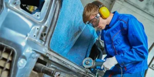 Image of collision repair technician at work