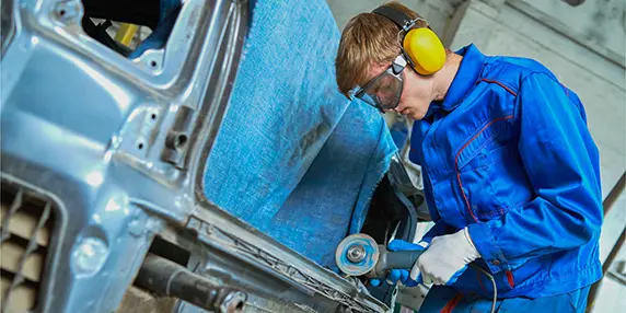 Image of collision repair technician at work